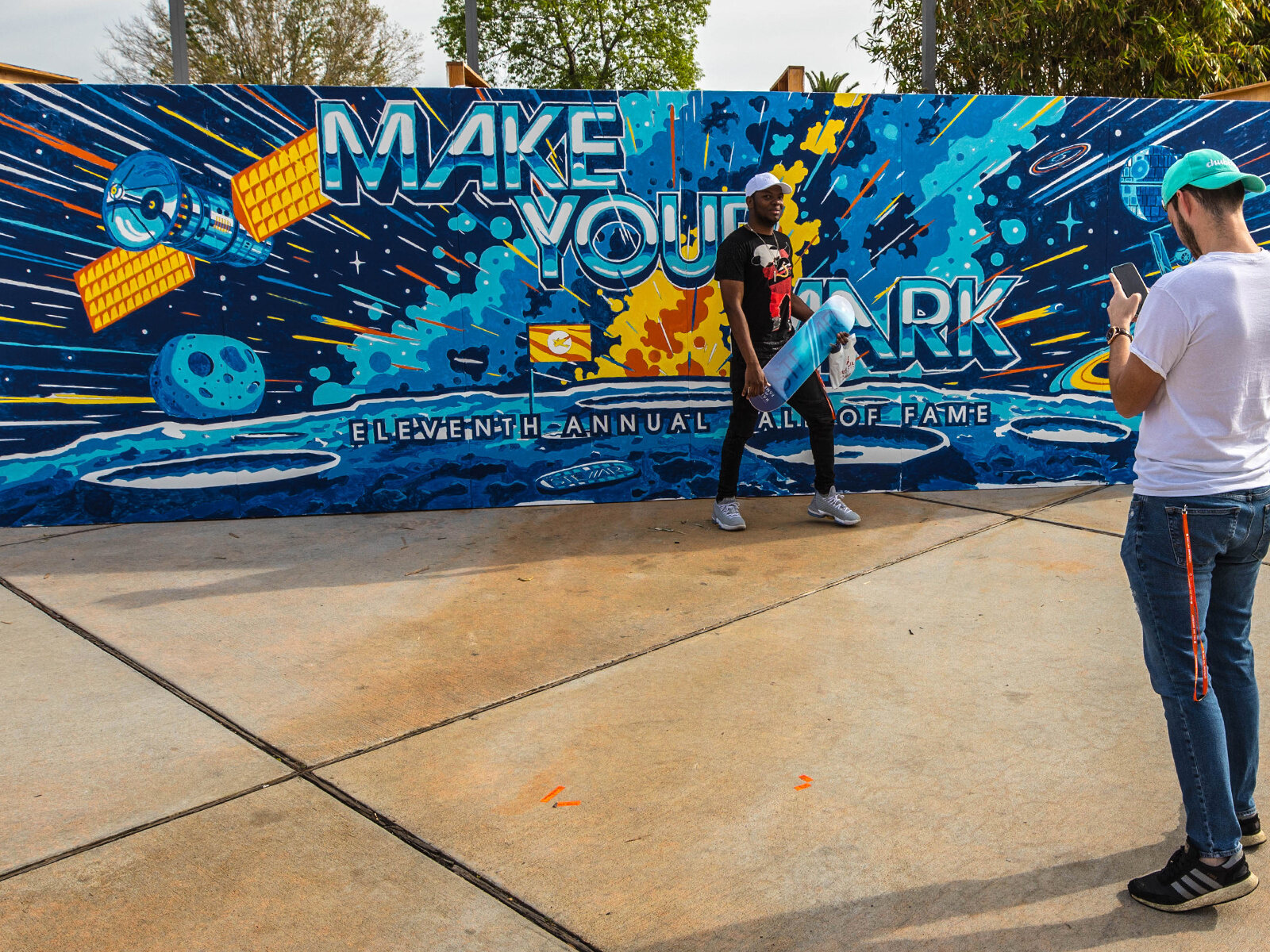 The Make Your Mark mural painted in, with visitors in front of it