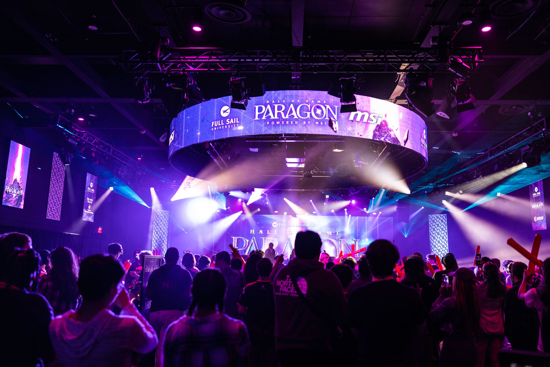 The crowd under the Paragon ring, with stage lights cutting through purple haze