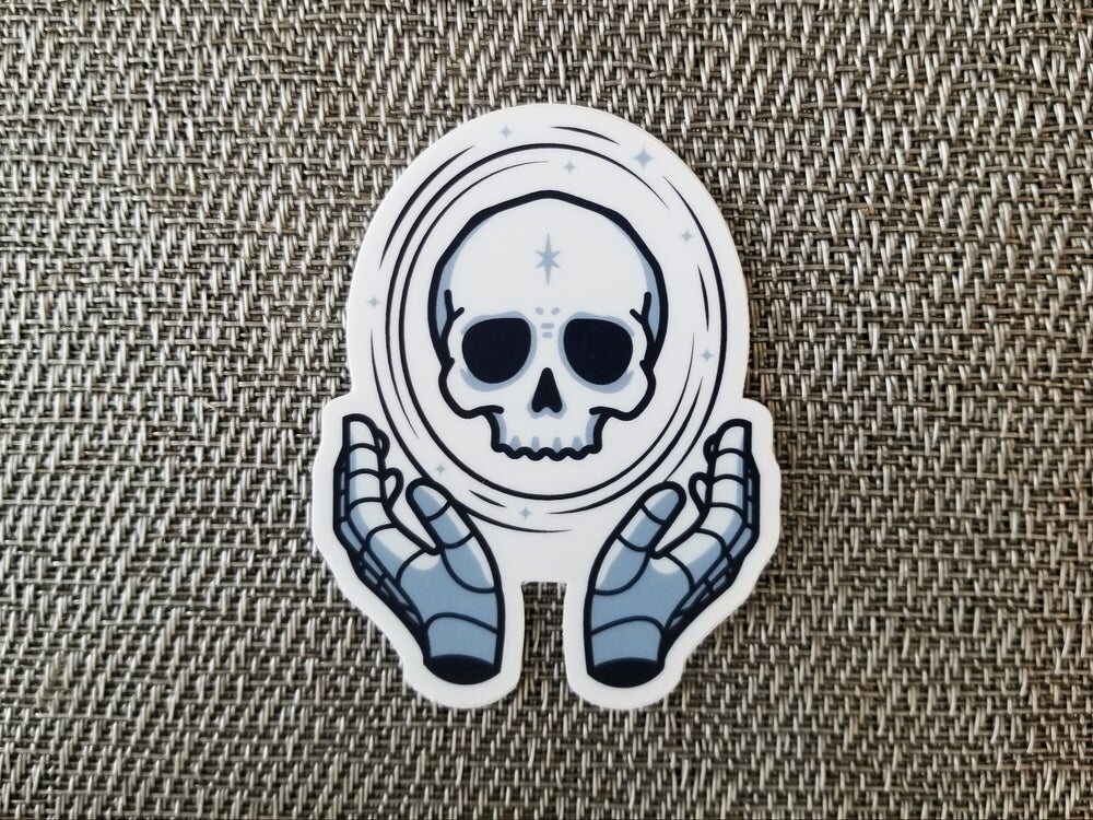 Sticker of two hands holding a glowing skull with a star on its forehead