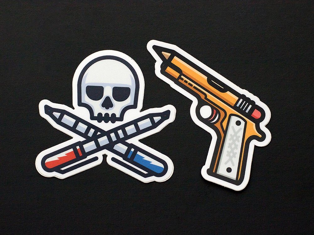 Two stickers: a skull over crossed pencil and marker, and a pistol made from a pencil
