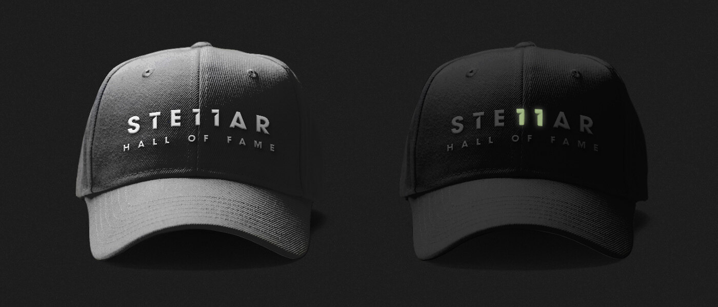 Two Stellar hats, one in light and one in the dark with the 11 glowing green
