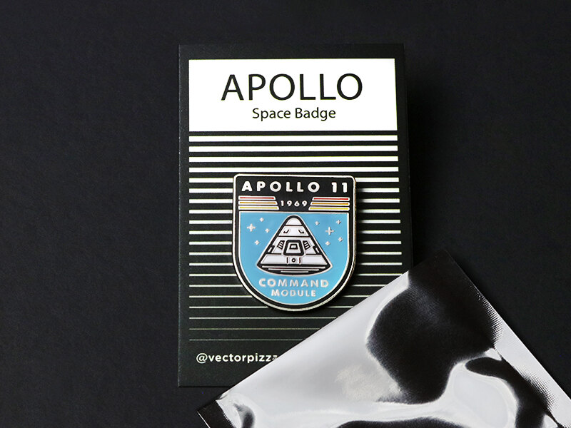 Apollo pin on a black backing card printed APOLLO Space Badge, with a mylar bag