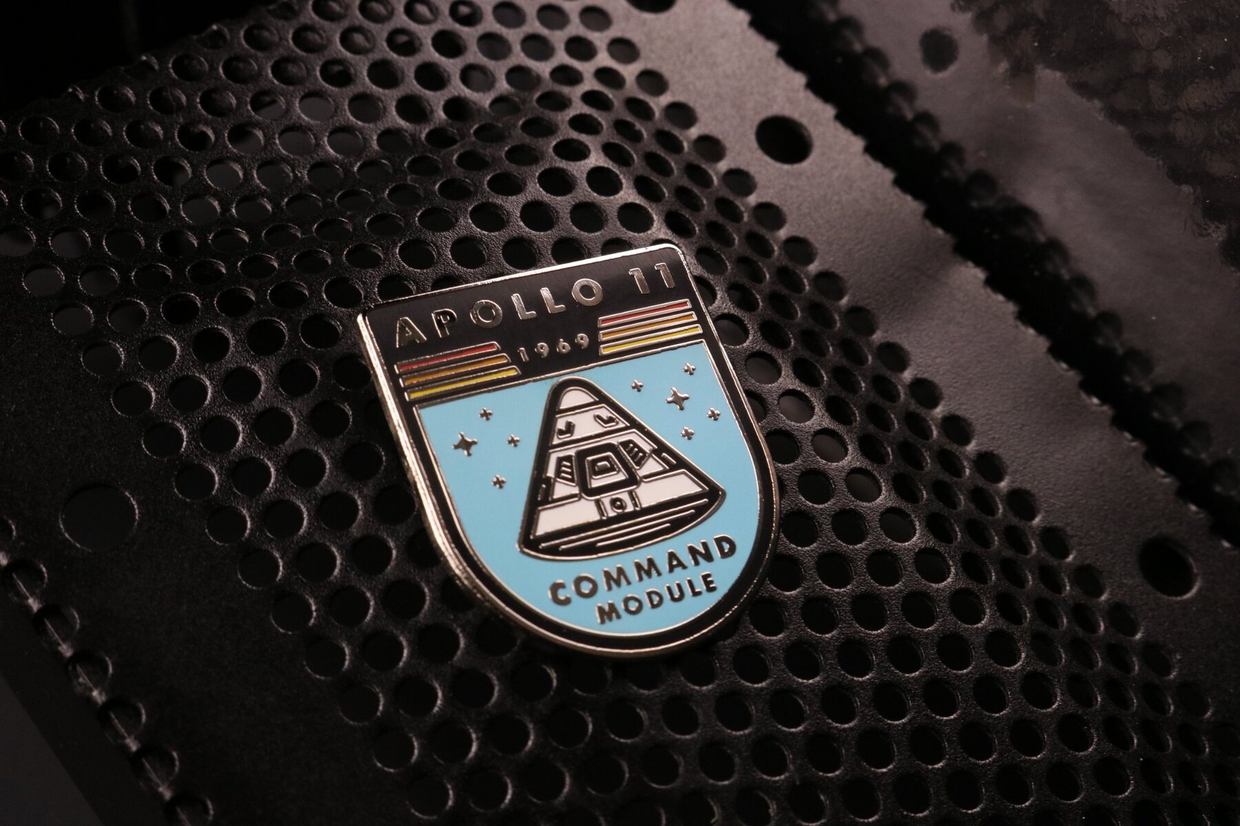 Apollo 11 Command Module enamel pin on perforated black metal