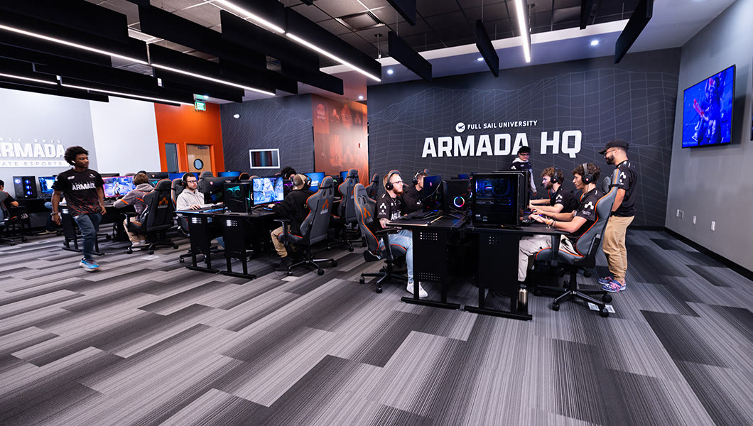 The Armada HQ esports room at Full Sail, with branded walls and players at their stations