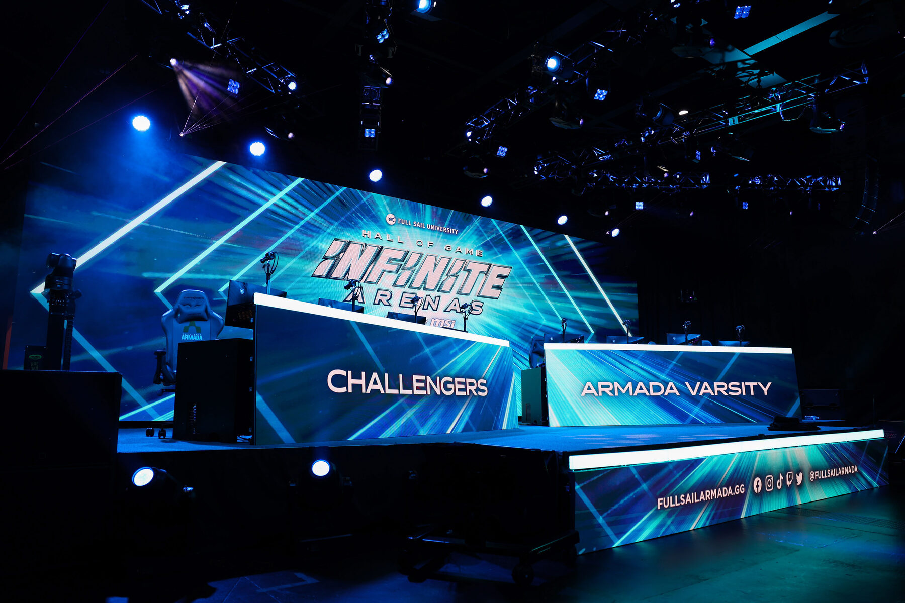 The stage from the side, with Challengers and Armada Varsity desks and a wraparound LED fascia
